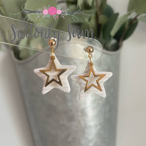 White and gold star dangle earrings